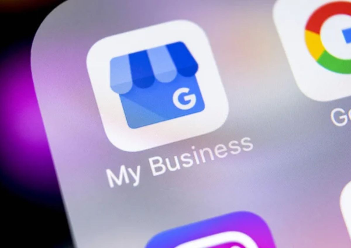 Image of Google My Business blue icon inside of a white square in front of a purple and black gradient background
