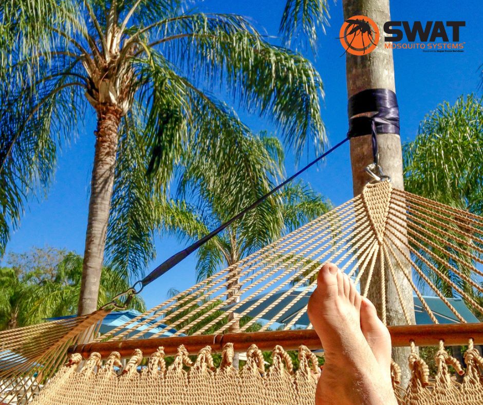 SWAT Mosquito Systems Facebook photo of man's foot resting on a hammock with Palm Trees and SWAT logo