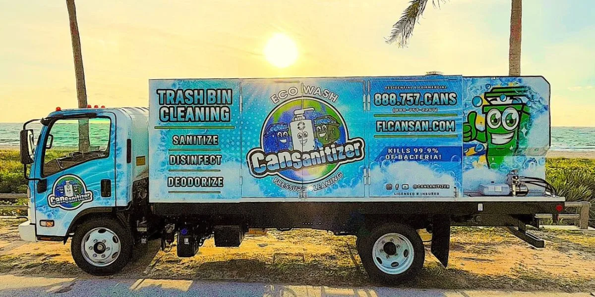 Service truck for Can Sanitizer with colorful branding parked by the seaside at sunset.